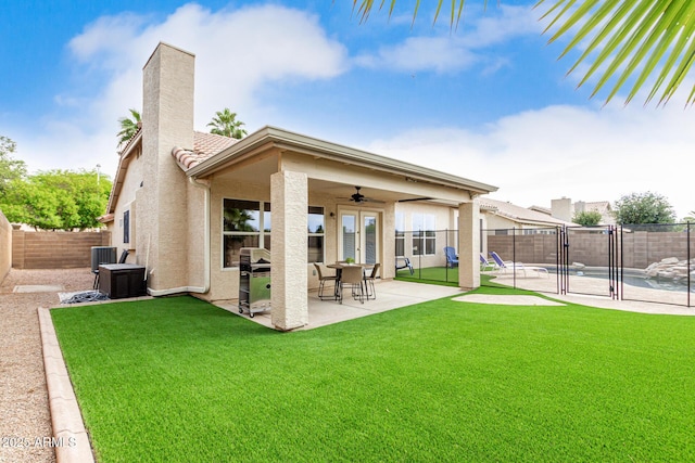 back of house featuring stucco siding, ceiling fan, a patio, a chimney, and central air condition unit