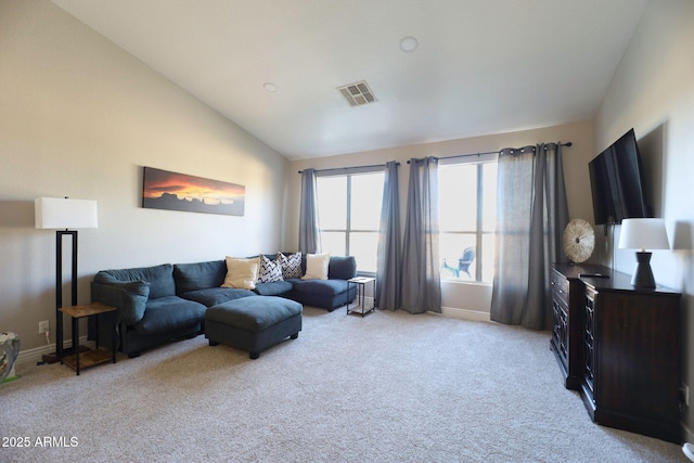 living room featuring light colored carpet, lofted ceiling, and baseboards