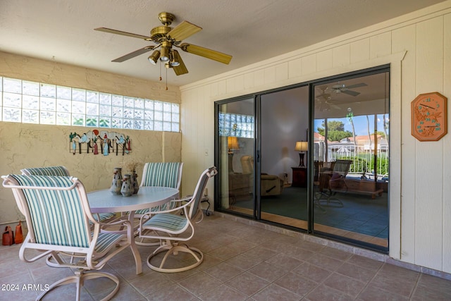 sunroom / solarium featuring ceiling fan