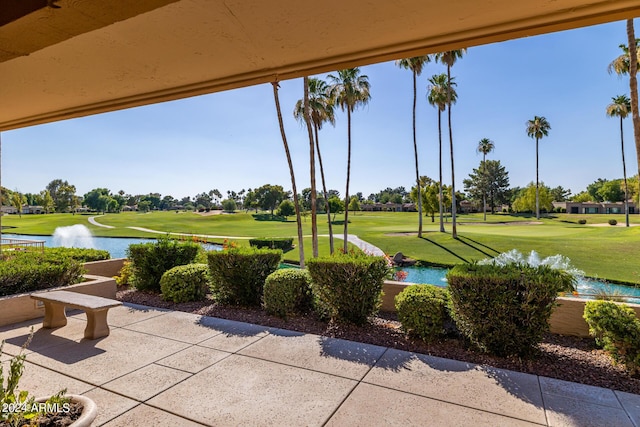 view of home's community featuring a water view and a yard