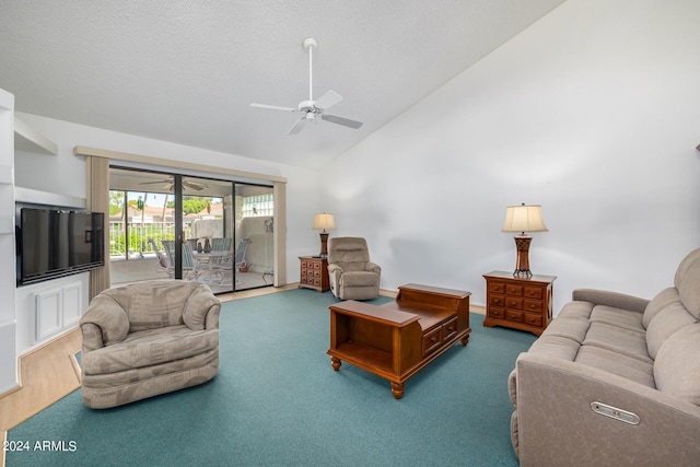 carpeted living room with ceiling fan, a textured ceiling, and high vaulted ceiling