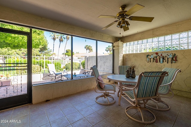 sunroom featuring ceiling fan