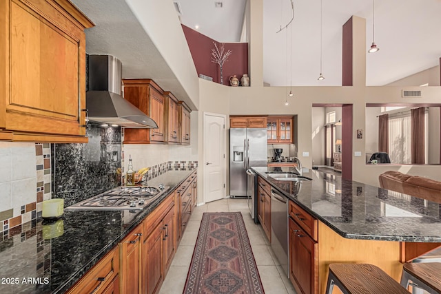 1635 W Windsong Dr, Phoenix, AZ 85045 - kitchen with wall chimney range hood, a sink, appliances with stainless steel finishes, and brown cabinetry