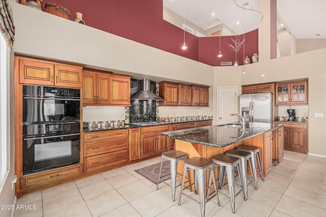1635 W Windsong Dr, Phoenix, AZ 85045 - kitchen with a sink, wall chimney exhaust hood, brown cabinetry, light tile patterned floors, and stainless steel appliances