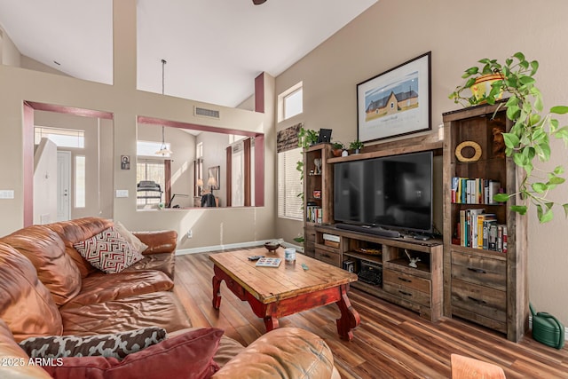 1635 W Windsong Dr, Phoenix, AZ 85045 - living room featuring baseboards, a wealth of natural light, visible vents, and wood finished floors