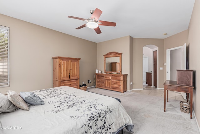 1635 W Windsong Dr, Phoenix, AZ 85045 - bedroom featuring arched walkways, ceiling fan, baseboards, and light carpet