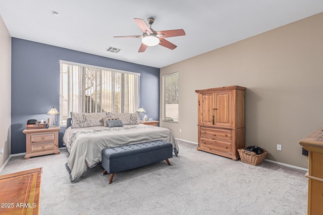 1635 W Windsong Dr, Phoenix, AZ 85045 - bedroom with baseboards, visible vents, a ceiling fan, and light colored carpet