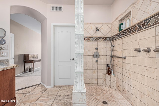 1635 W Windsong Dr, Phoenix, AZ 85045 - full bath with baseboards, a tile shower, visible vents, and vanity