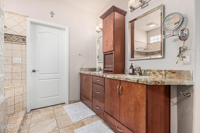 1635 W Windsong Dr, Phoenix, AZ 85045 - full bathroom featuring double vanity, a sink, stone tile floors, and a tile shower