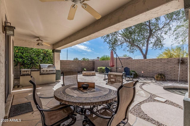1635 W Windsong Dr, Phoenix, AZ 85045 - view of patio / terrace featuring ceiling fan, a fenced backyard, grilling area, a fire pit, and an outdoor kitchen