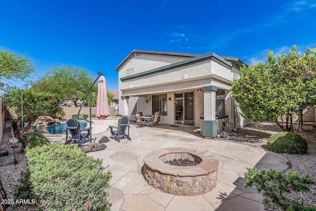 1635 W Windsong Dr, Phoenix, AZ 85045 - rear view of house featuring stucco siding, a fire pit, a fenced backyard, and a patio area