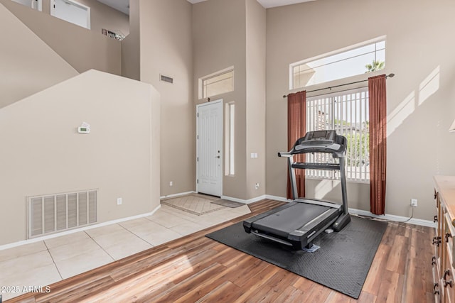 1635 W Windsong Dr, Phoenix, AZ 85045 - workout room featuring a high ceiling, wood finished floors, baseboards, and visible vents