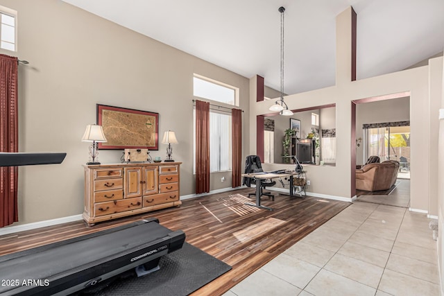 1635 W Windsong Dr, Phoenix, AZ 85045 - exercise room with baseboards, high vaulted ceiling, and wood finished floors