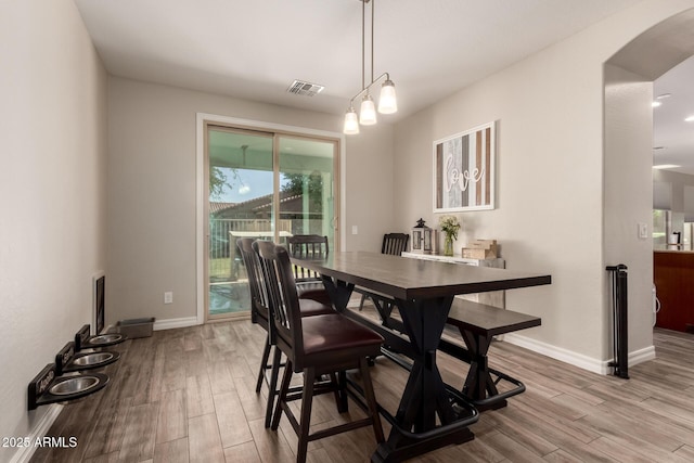1217 W Fever Tree Ave, San Tan Valley, AZ 85140 - dining area with wood finished floors, baseboards, and arched walkways