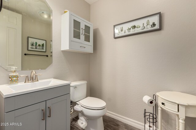 1217 W Fever Tree Ave, San Tan Valley, AZ 85140 - bathroom with wood finished floors, toilet, baseboards, and vanity