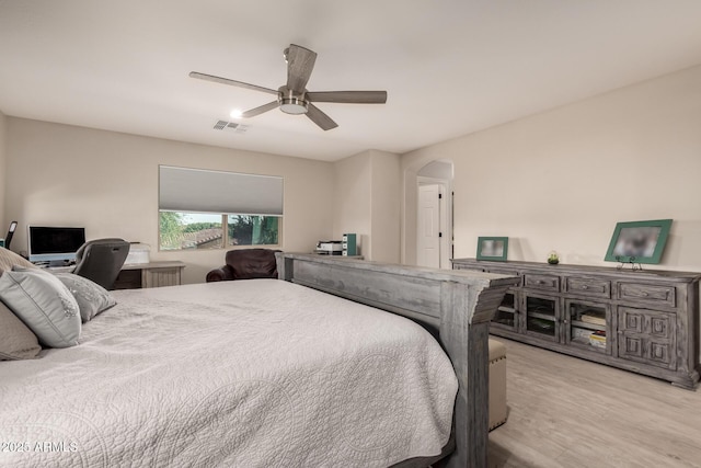 1217 W Fever Tree Ave, San Tan Valley, AZ 85140 - bedroom with light wood-style flooring, arched walkways, and ceiling fan