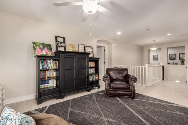 1217 W Fever Tree Ave, San Tan Valley, AZ 85140 - sitting room with an upstairs landing, arched walkways, ceiling fan, light wood-style floors, and recessed lighting