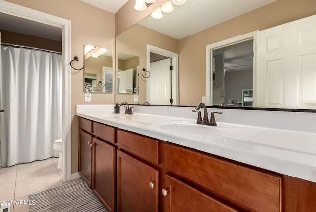 1217 W Fever Tree Ave, San Tan Valley, AZ 85140 - bathroom featuring toilet, double vanity, and tile patterned flooring