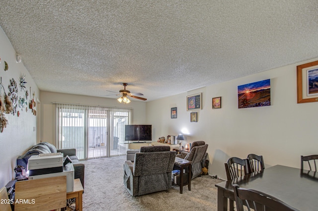 living room featuring ceiling fan, a textured ceiling, and carpet flooring