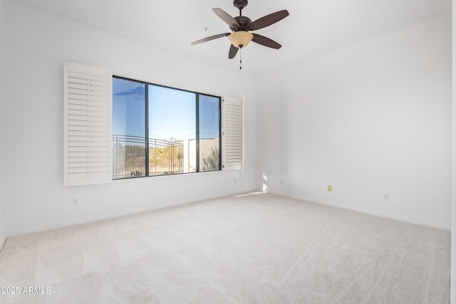 unfurnished room with ceiling fan and light colored carpet