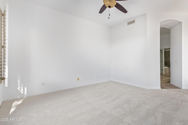 carpeted spare room featuring ceiling fan