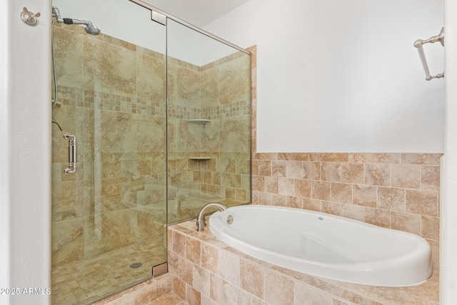 bathroom featuring shower with separate bathtub