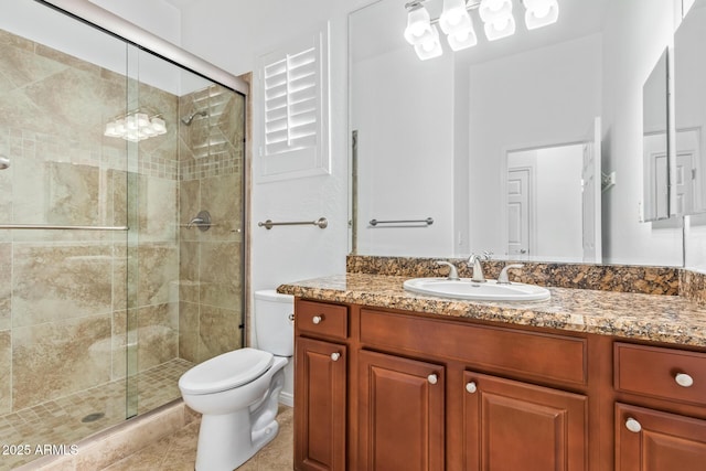 bathroom featuring toilet, tile patterned floors, walk in shower, and vanity