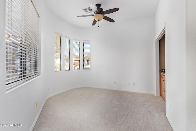 carpeted empty room featuring ceiling fan