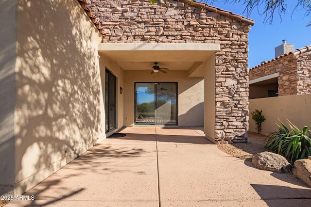 property entrance with ceiling fan and a patio area