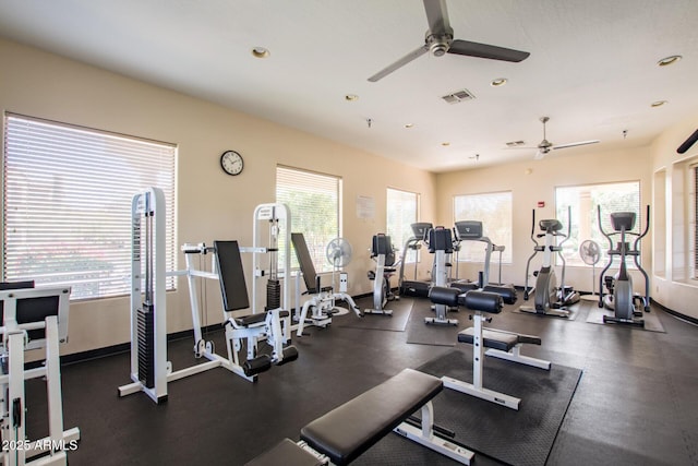 gym with ceiling fan and a wealth of natural light