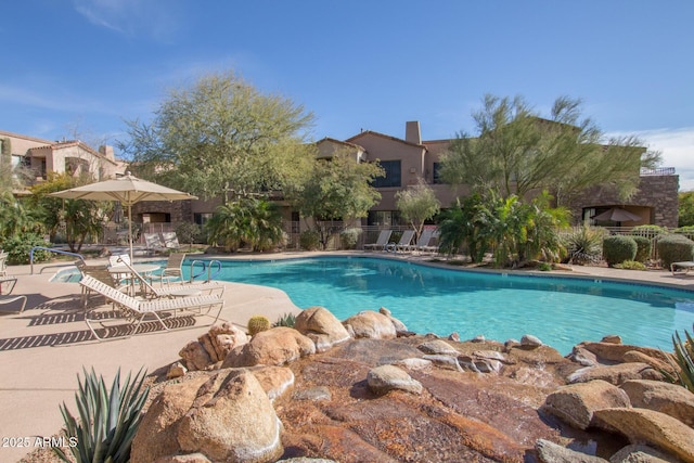 view of swimming pool with a patio