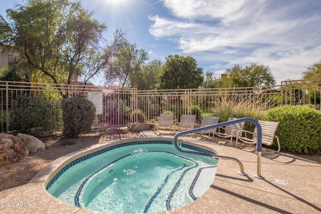 view of swimming pool with a patio area and an in ground hot tub