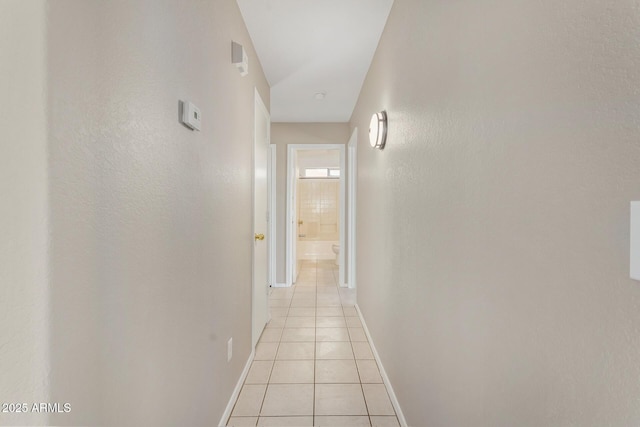 hall with light tile patterned floors