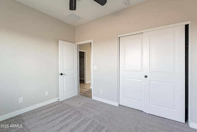 unfurnished bedroom featuring visible vents, a closet, baseboards, and carpet flooring