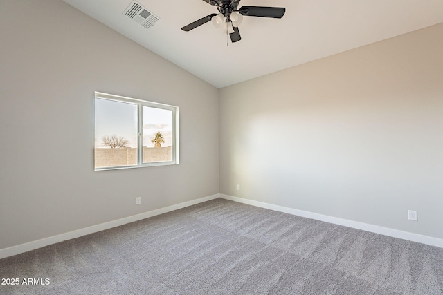 unfurnished room featuring carpet floors, baseboards, visible vents, and vaulted ceiling