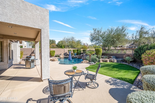 view of patio featuring a grill, pool water feature, and a fenced in pool