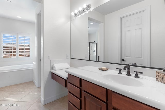 bathroom with a tub to relax in, tile patterned flooring, and vanity