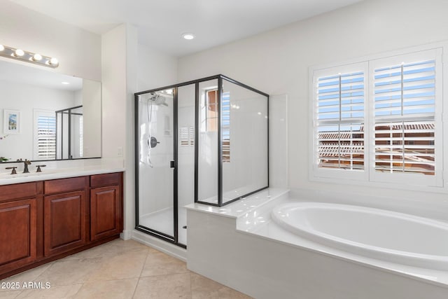 bathroom with independent shower and bath, vanity, and tile patterned floors