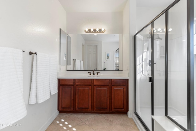 bathroom with vanity, an enclosed shower, and tile patterned floors