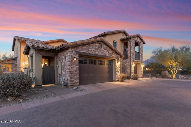 mediterranean / spanish home with a garage