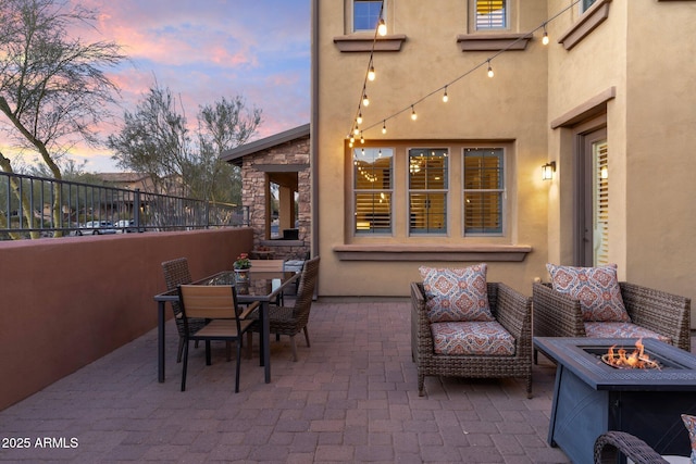 patio terrace at dusk with an outdoor fire pit