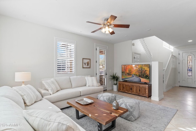 tiled living room with ceiling fan