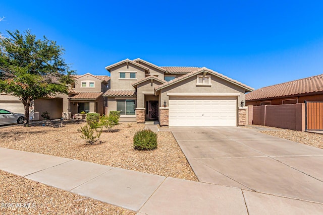 509 S 111th Dr, Avondale, AZ 85323 - view of front of house featuring stucco siding, a garage, driveway, and a tiled roof