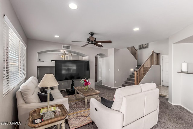 509 S 111th Dr, Avondale, AZ 85323 - living room with ceiling fan, arched walkways, carpet flooring, stairs, and recessed lighting