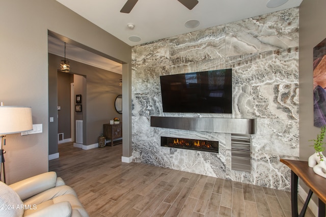 living room with wood-type flooring and ceiling fan