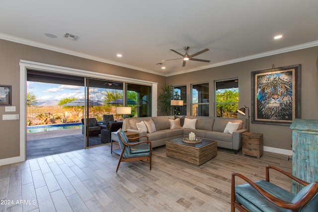 living room featuring light hardwood / wood-style flooring, ornamental molding, and ceiling fan