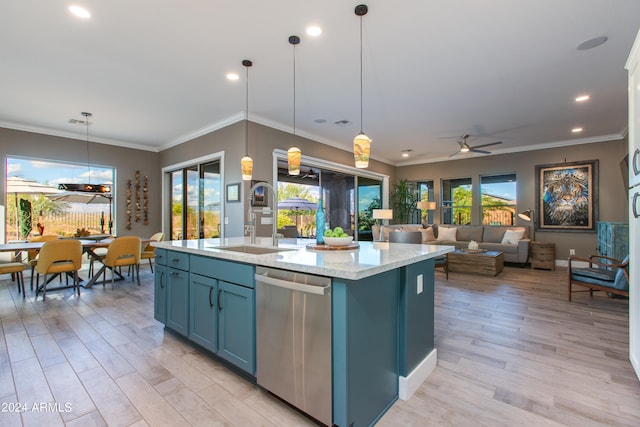 kitchen featuring decorative light fixtures, sink, stainless steel dishwasher, and an island with sink