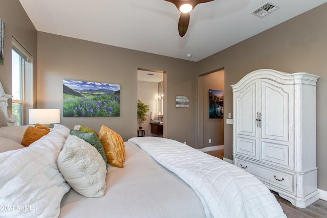 bedroom with hardwood / wood-style floors, ensuite bath, and ceiling fan