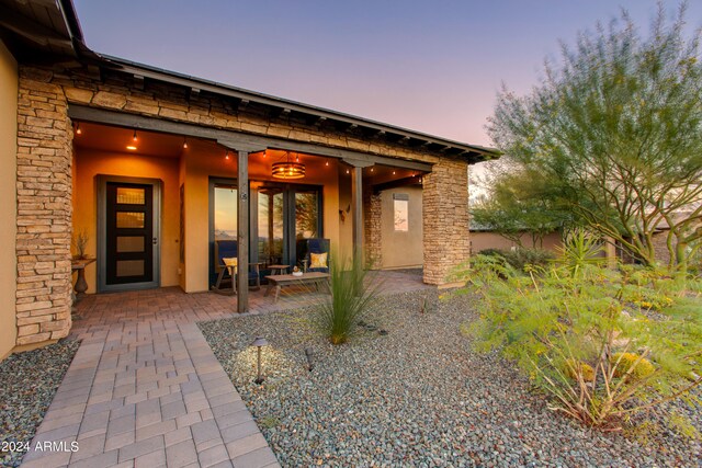 exterior entry at dusk with a patio