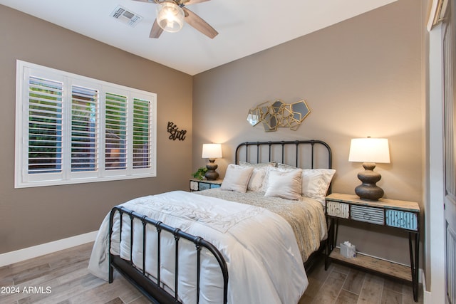 bedroom with wood-type flooring and ceiling fan